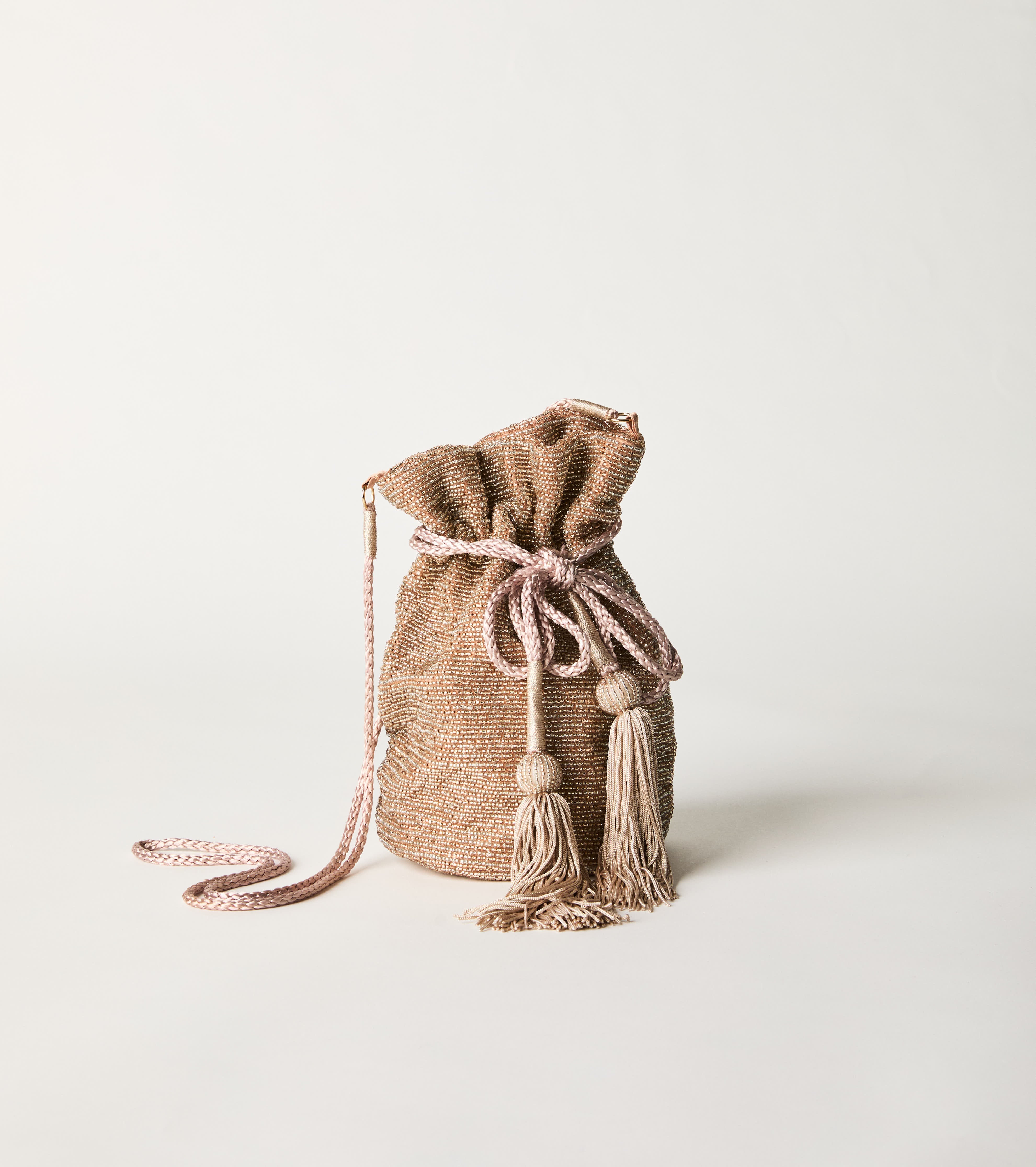 Bucket bag with drawstring and pink tassels