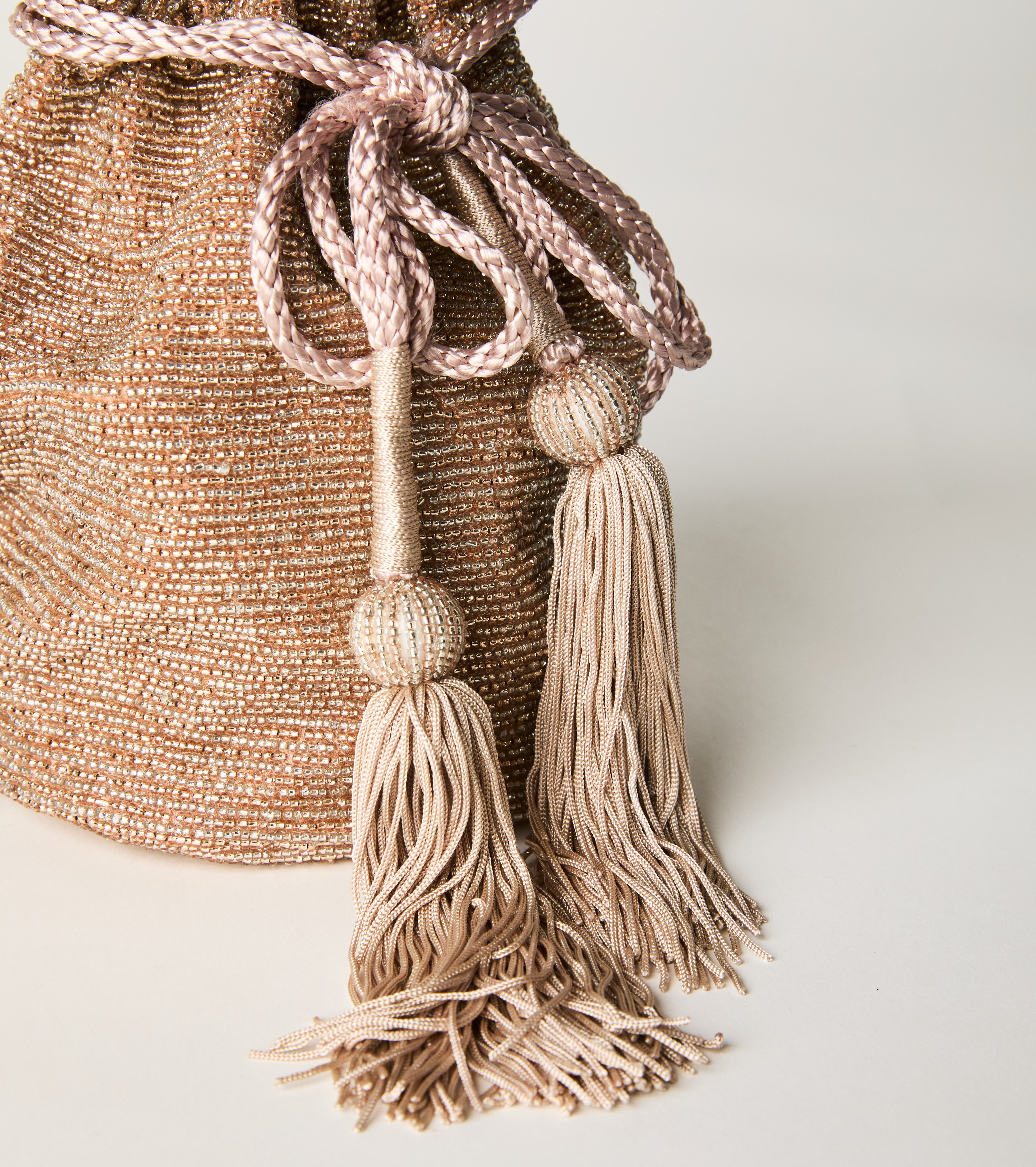 Bucket bag with drawstring and pink tassels